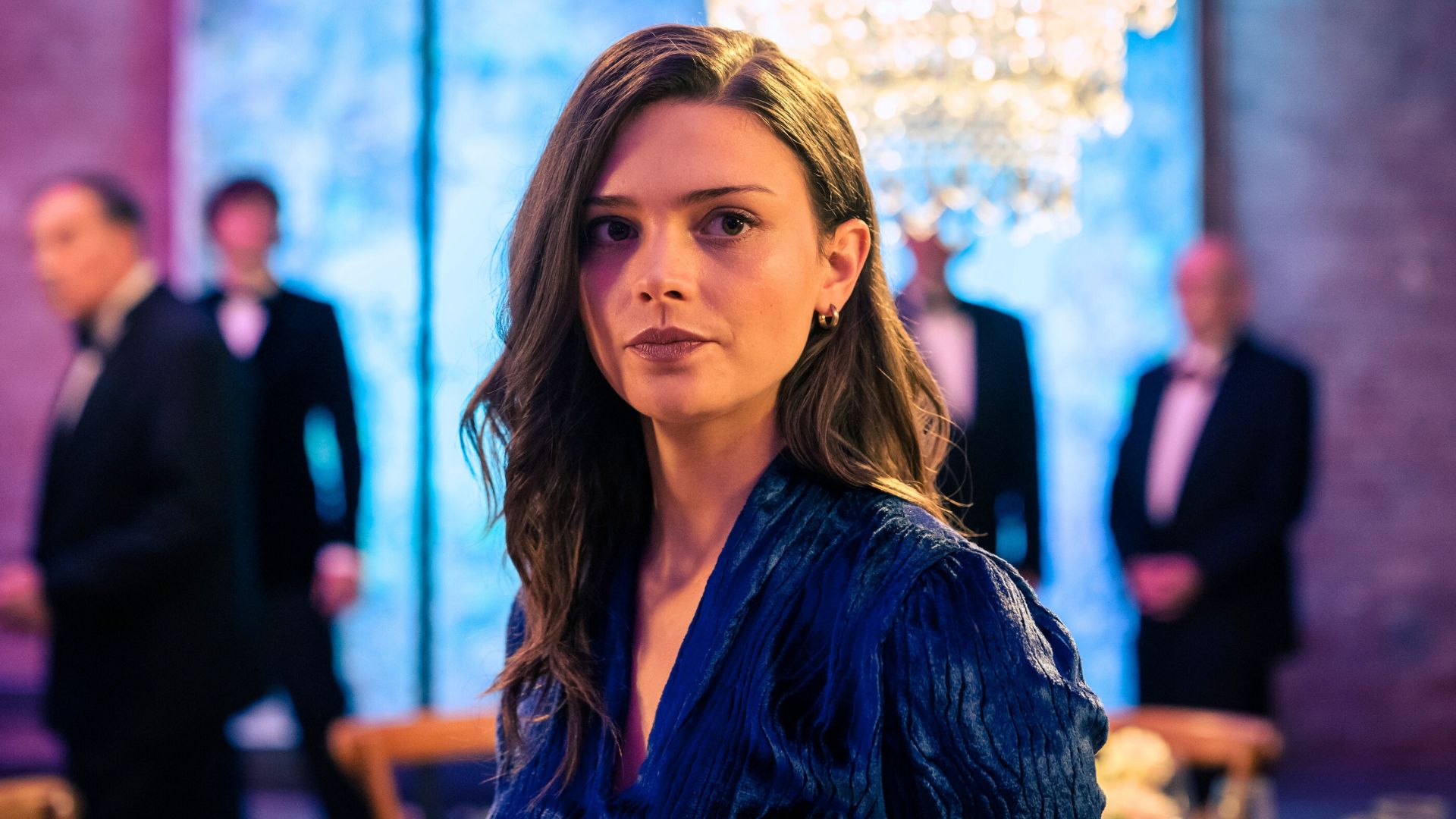 Ruby looks over her shoulder at something offscreen